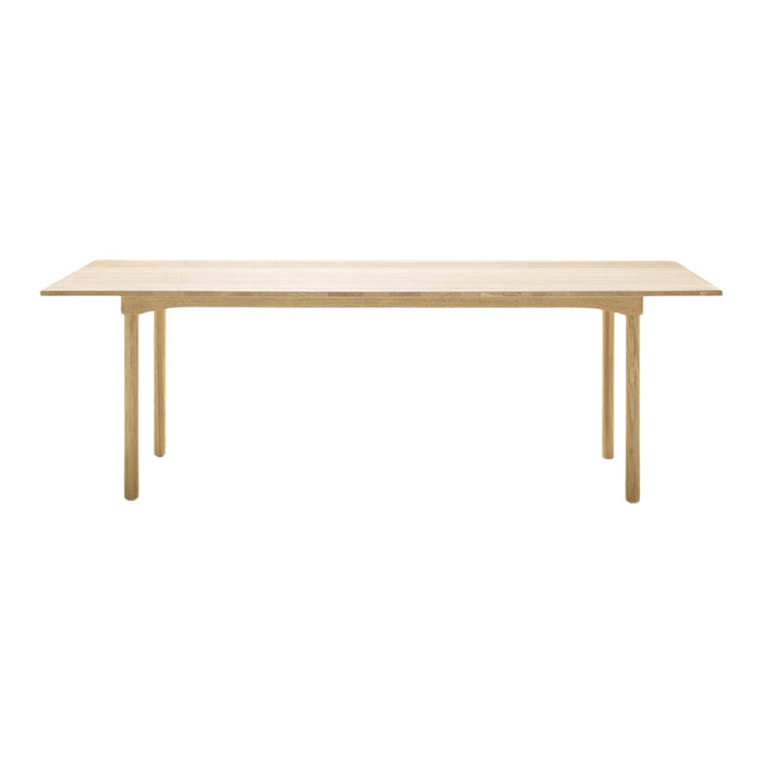 Light wood dining table with a smooth, plain surface and simple, natural finish, ideal for modern interiors.