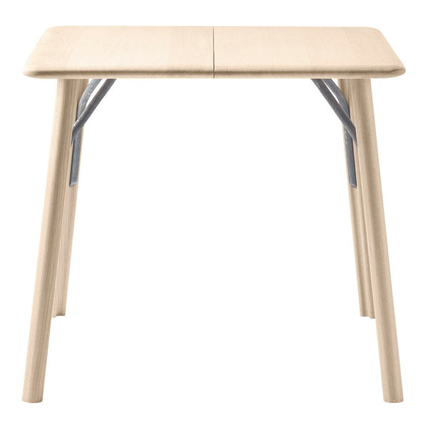 Light beige folding table with smooth surface and metallic gray accents on the legs, ideal for versatile setups.