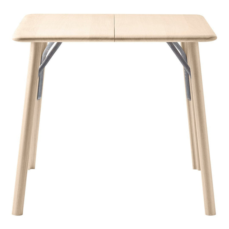 Light beige folding table with smooth surface and metallic gray accents on the legs, ideal for versatile setups.