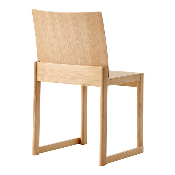 Natural light wood chair with a smooth finish and minimalist design, featuring clean lines and no visible patterns.
