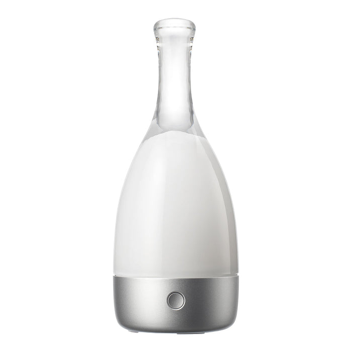 White glass diffuser with a sleek silver base, featuring a minimalist design and smooth, modern curves.