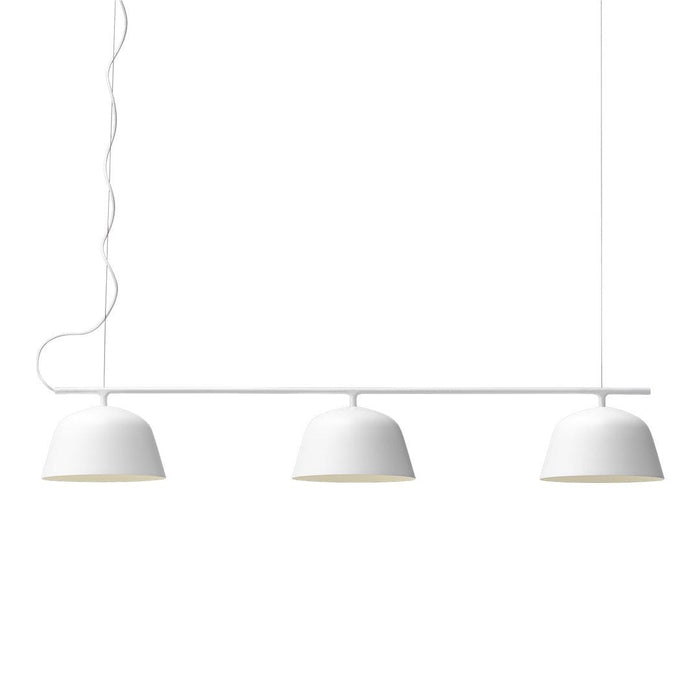 Three sleek white pendant lights with smooth, curved, matte finish shades. Minimalist design with subtle elegance.