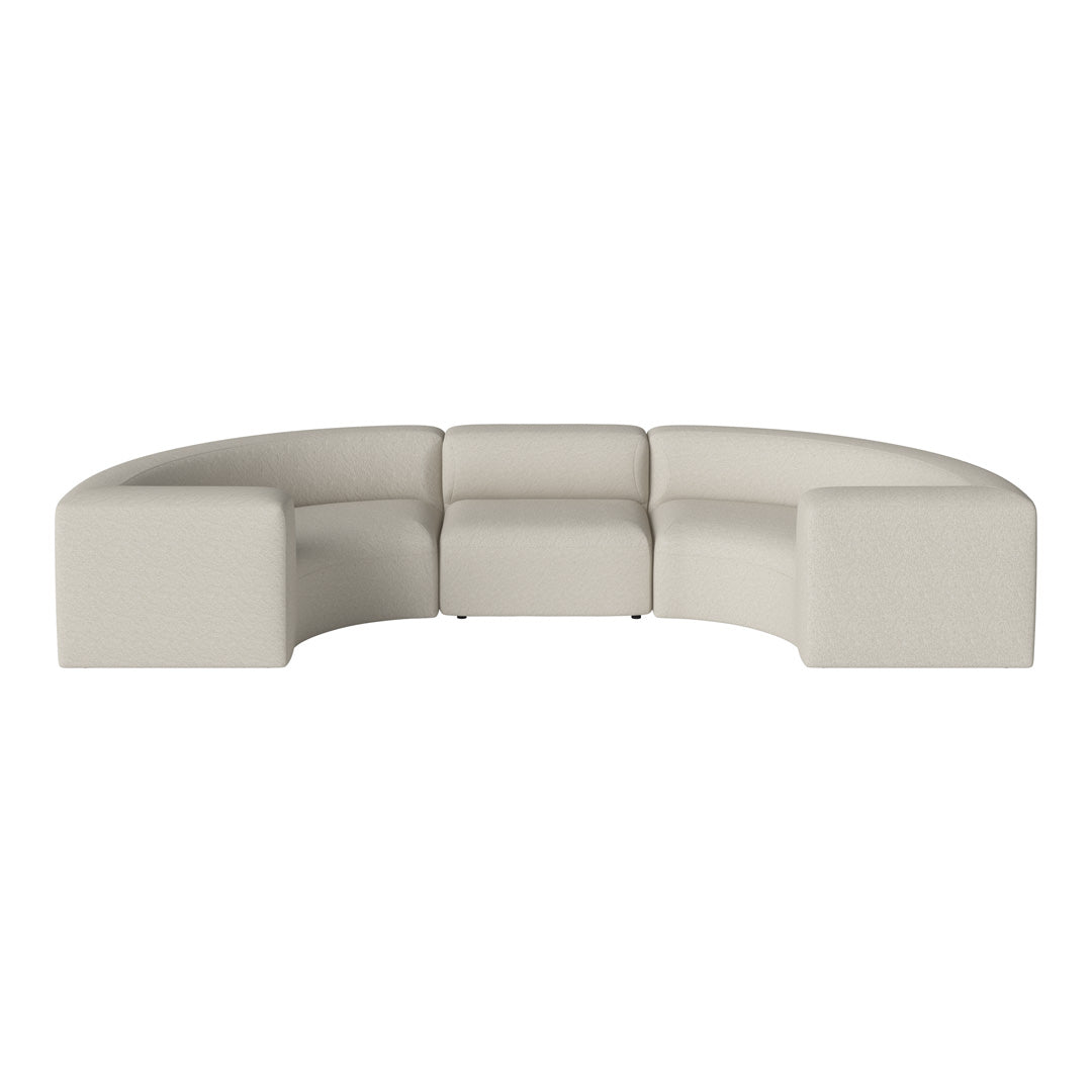 Curved sectional sofa in soft beige fabric with a textured pattern, ideal for modern living spaces.