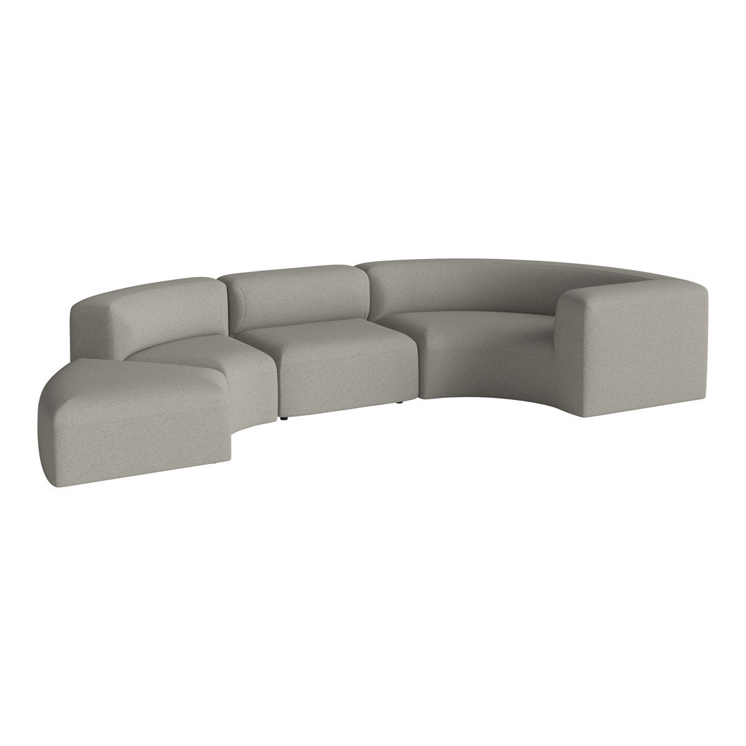 Curved modular sofa in soft gray fabric with smooth, minimalist design and no visible patterns.