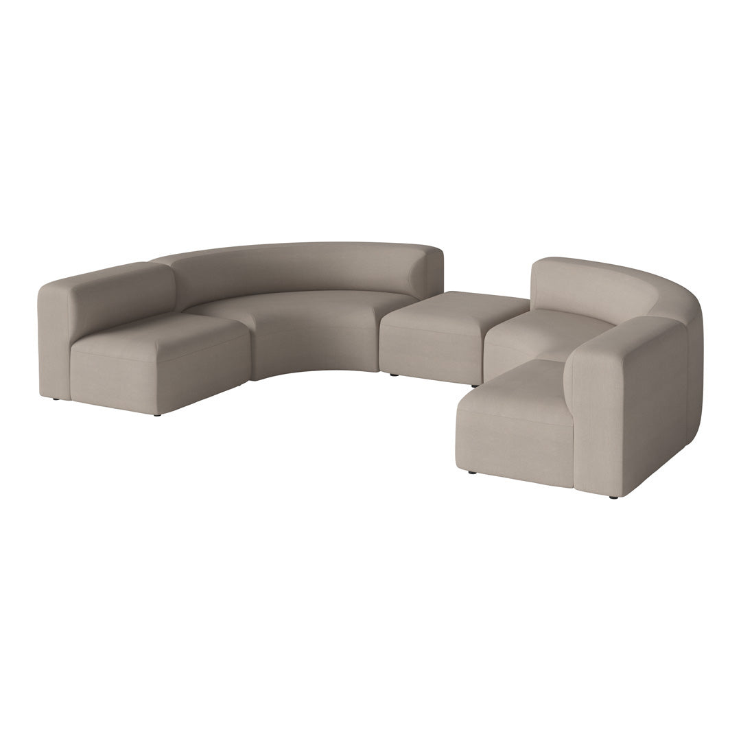 Curved modular sofa in soft beige upholstery with smooth, minimalist design. Perfect for modern living spaces.
