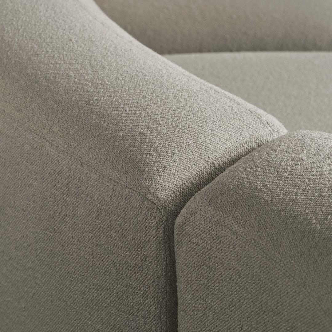 Close-up of light gray textured fabric with subtle patterns, highlighting a soft, modern aesthetic.