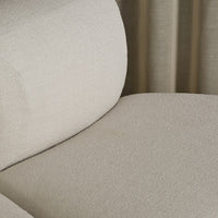 Light beige textured upholstery with a subtle pattern, perfect for modern decor.