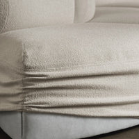Beige textured upholstery with subtle sheen and layered patterns on a plush sofa. Soft, neutral tones ideal for any decor.
