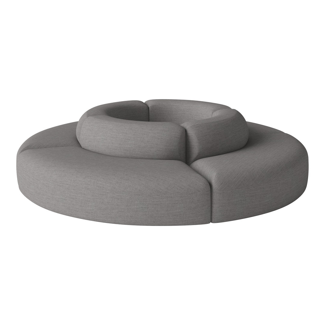 Circular gray sofa with a smooth fabric texture and minimalist design, featuring layered rounded sections.