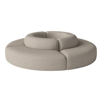 Beige circular sofa with smooth, rounded forms and a textured fabric finish. Modern and minimalist design.
