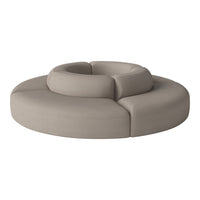 Beige circular sofa with soft, rounded sections and a smooth, textured fabric finish.