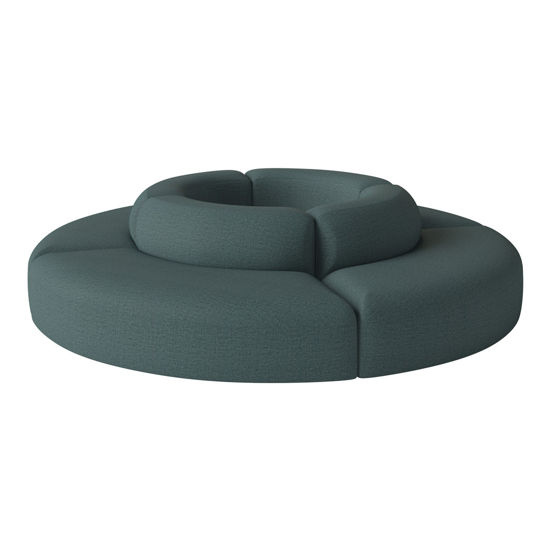 Teal circular sofa with textured fabric, featuring a modern design and seamless, soft curves. Perfect for stylish interiors.