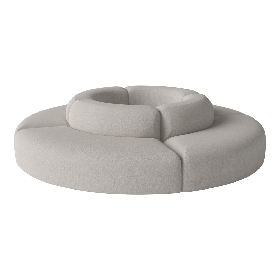 Round, soft gray sofa with a modern abstract design, featuring smooth lines and a plush texture. Perfect for contemporary interiors.