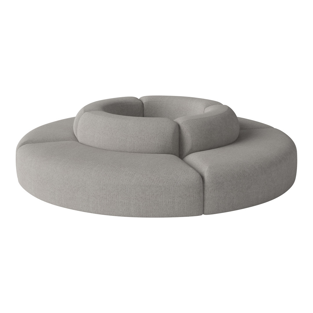 Gray circular sofa with layered, plush seating and smooth fabric texture. Modern design for contemporary interiors.
