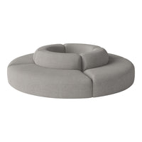 Gray circular sofa with layered, plush seating and smooth fabric texture. Modern design for contemporary interiors.