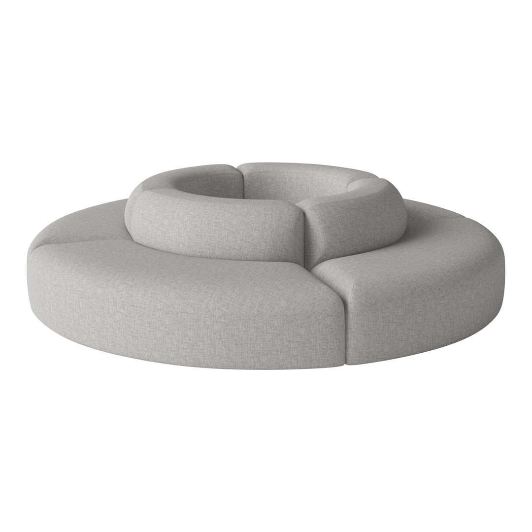 Gray circular sofa with a textured pattern, featuring smooth, rounded shapes for modern decor.