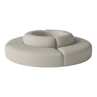 Beige circular sofa with smooth, textured upholstery and rounded sections for a cozy, modern design.