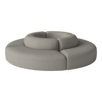 Circular gray sofa with smooth, textured fabric and modern contours, perfect for contemporary decor.