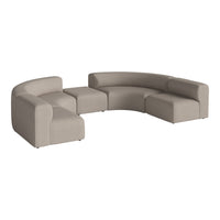 Curved sectional sofa in soft beige fabric with minimalistic design, ideal for modern living spaces.