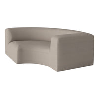 Curved sofa in soft beige fabric with subtle texture, perfect for modern indoor decor.