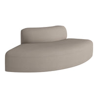 Curved beige sofa with a smooth texture, featuring a minimalist design and subtle striped pattern. Perfect for modern decor.