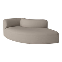 Light taupe curved sofa with subtle texture, featuring a smooth, modern design and minimalist aesthetic.