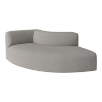 Curved gray sofa with a textured fabric, showcasing a minimalist design and soft, modern aesthetics.