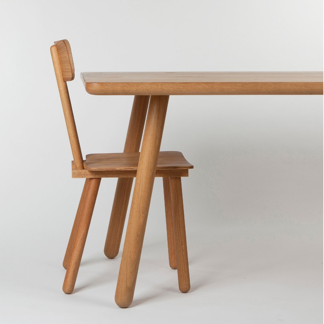 Natural wood table and chair set, showcasing warm oak tones and minimalist design with smooth, clean lines.