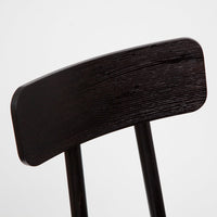 Close-up of a sleek, dark wood chair back with textured, grainy pattern against a neutral background.