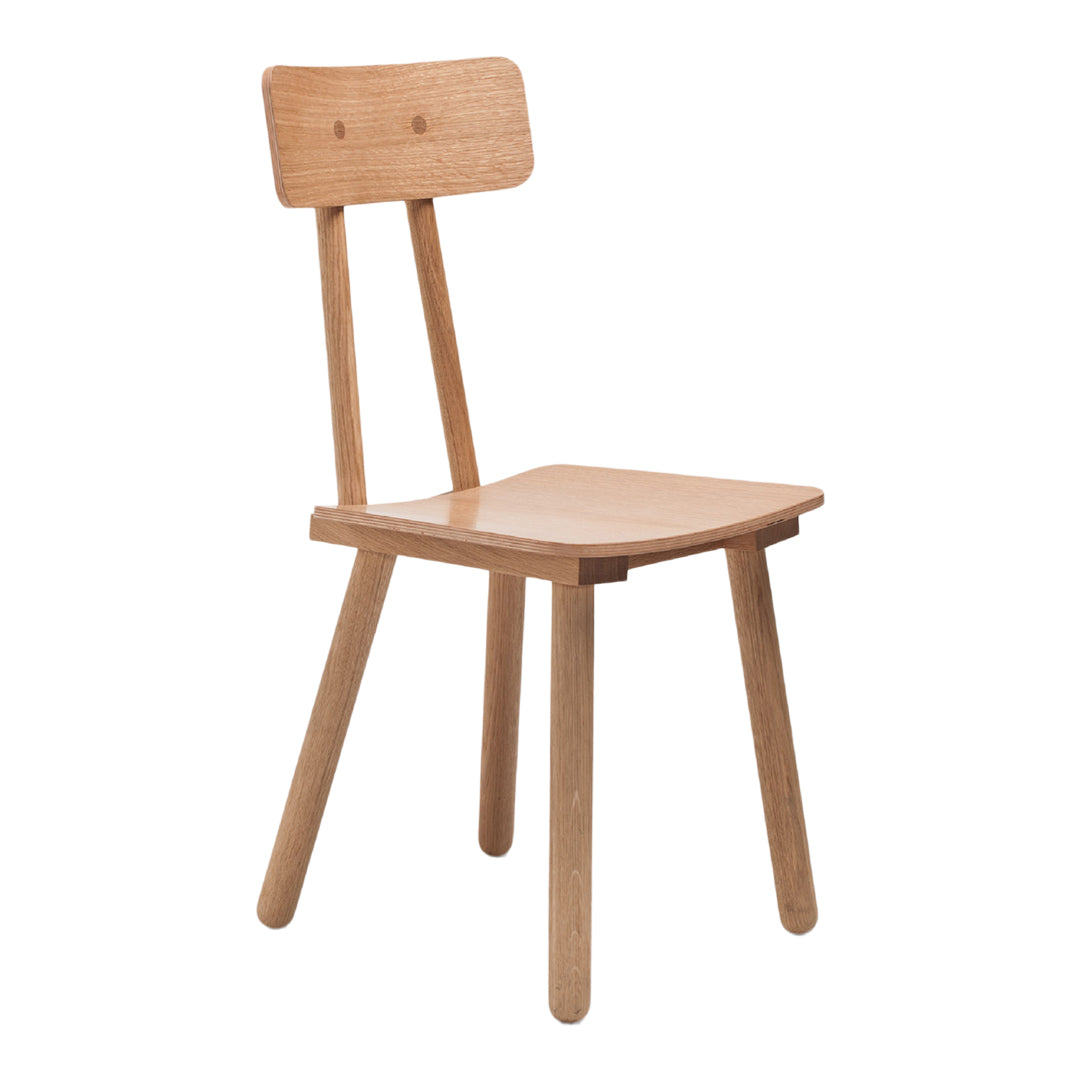 Light oak dining chair with a minimalist design and natural wood grain pattern. Perfect for modern interiors.