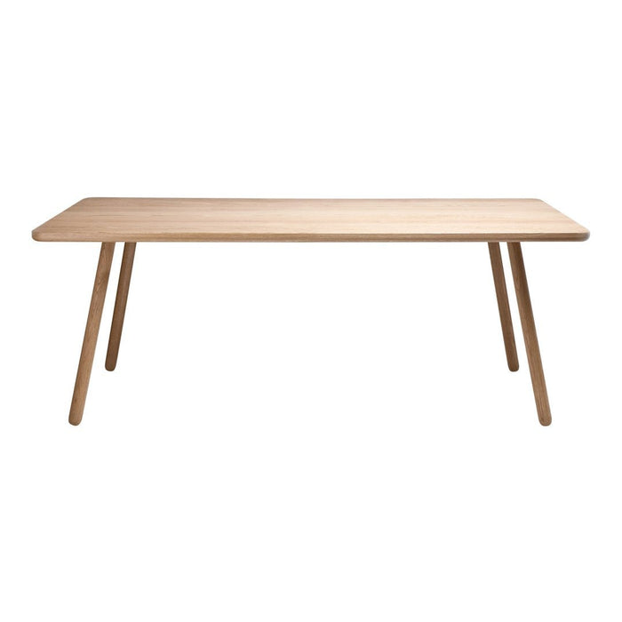 Light wood dining table with a smooth, natural finish and minimalist design, featuring slender, angled legs.