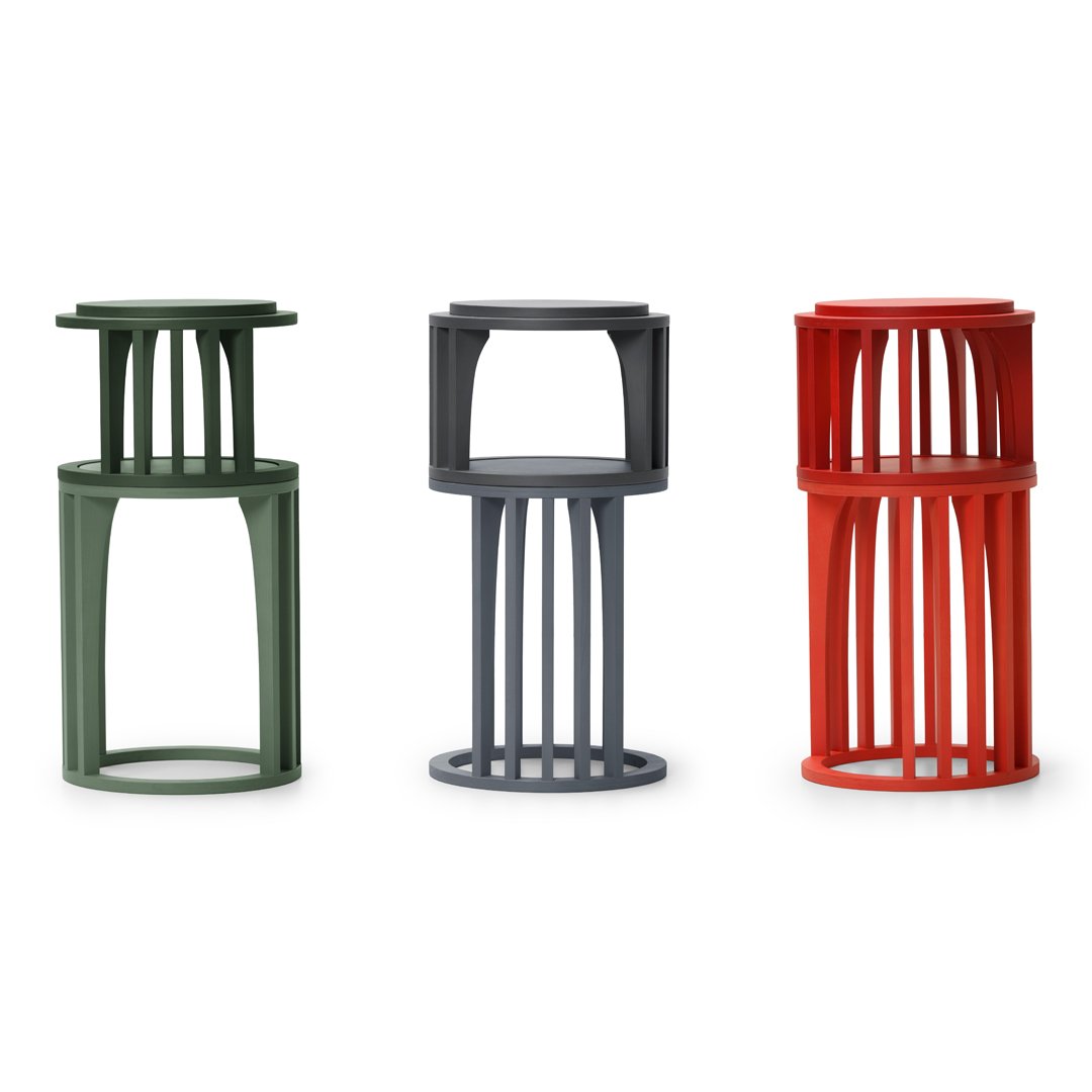 Three modern stools in olive green, charcoal gray, and vibrant red with a unique slatted design.