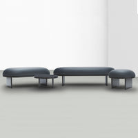 Contemporary dark gray sectional sofa with smooth upholstery and minimalist design, featuring rounded edges.
