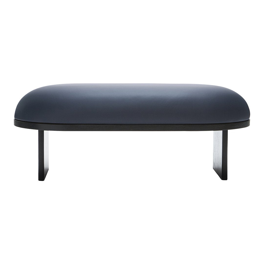 Modern navy blue coffee table with a smooth, rounded top and sleek black legs, perfect for contemporary decor.