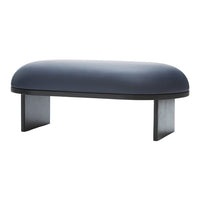 Navy blue oval ottoman with a smooth surface and minimalist black legs. Modern and stylish design for interior decor.