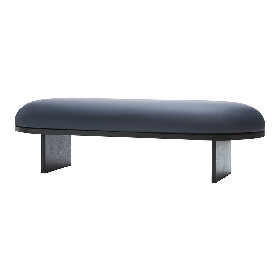 Modern blue upholstered bench with a sleek black base, featuring a smooth, rounded design and minimalist style.