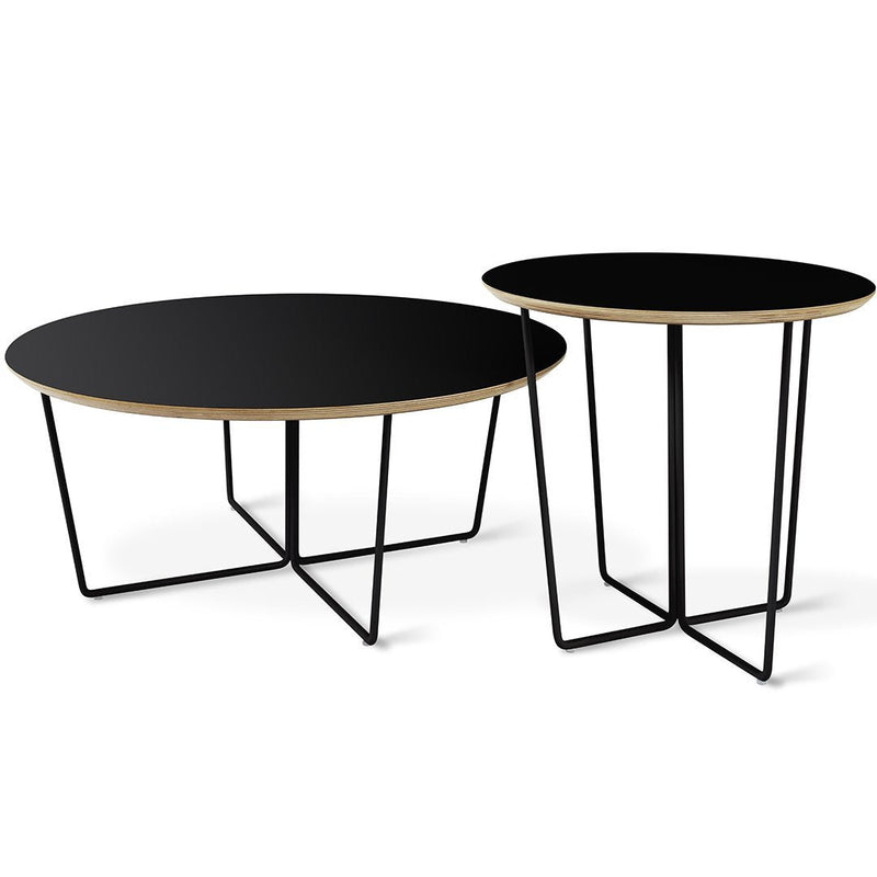 Black round coffee tables with natural wood edges and sleek black metal legs in a modern design.