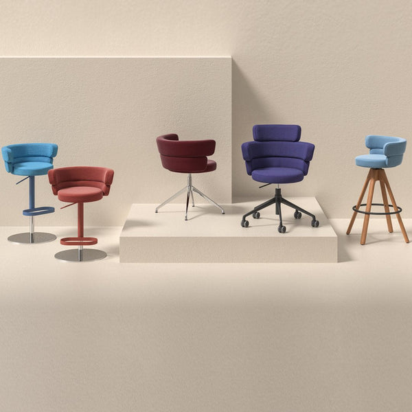 Colorful modern chairs in blue, maroon, purple, and red with varied patterns and material finishes. Stylish and vibrant designs.