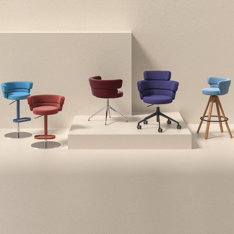 Colorful modern chairs in blue, maroon, purple, and red with varied patterns and material finishes. Stylish and vibrant designs.