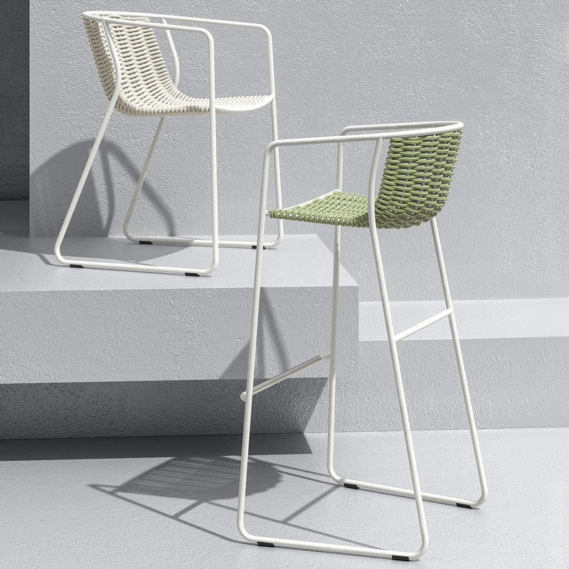 White and green woven bar stools with sleek metal frames, perfect for modern decor.