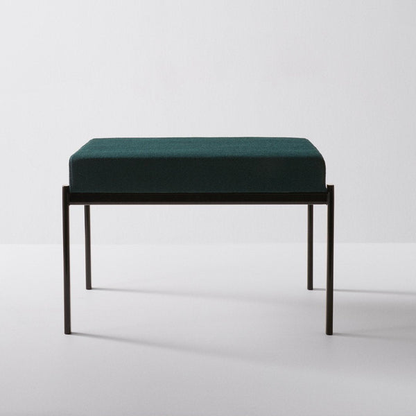 Teal velvet cushion on a sleek black metal frame, featuring a minimalist design for modern decor.