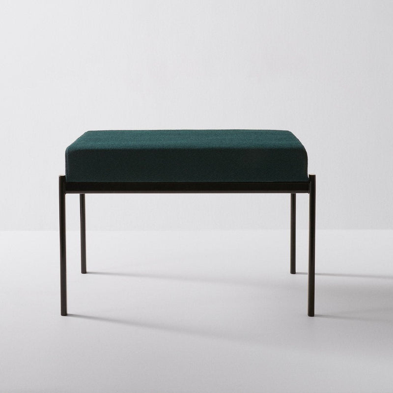 Teal velvet cushion on a sleek black metal frame, featuring a minimalist design for modern decor.