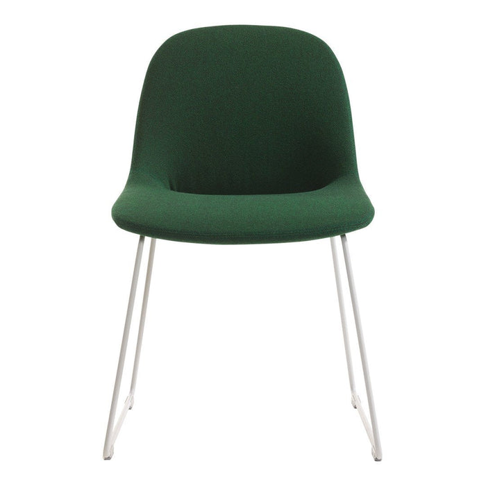 Green upholstered chair with a smooth finish and sleek silver legs. Perfect for modern decor.