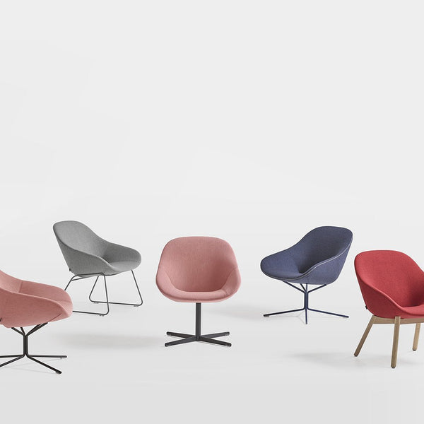 Colorful chairs in soft pink, grey, blue, and red finishes with sleek patterns and modern designs.