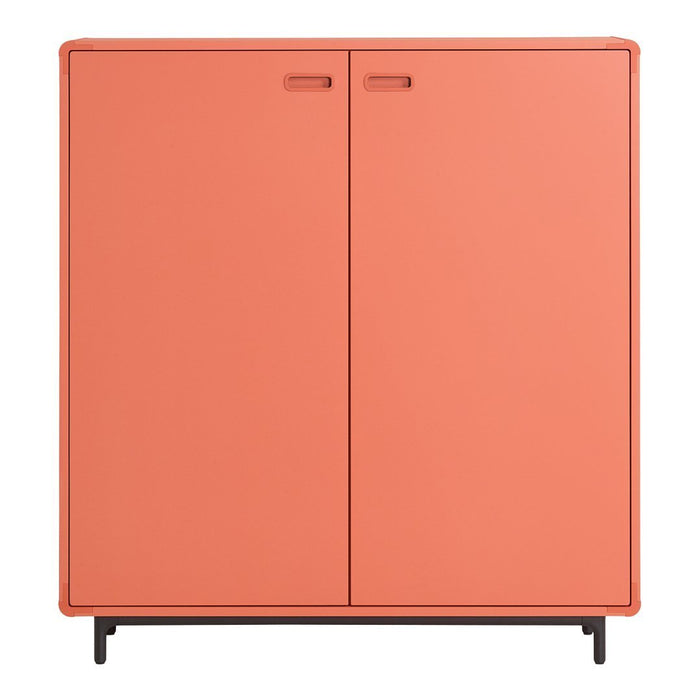 Coral-colored cabinet with a sleek, modern design and minimalist black legs, featuring two smooth front doors.