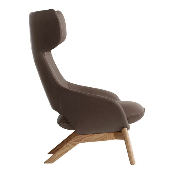 Stylish brown upholstered armchair with a minimalist design and natural wood legs, featuring smooth curves and clean lines.