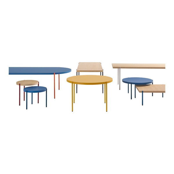 Colorful modern tables featuring blue, yellow, and natural wood finishes with sleek minimalist designs and vibrant legs.