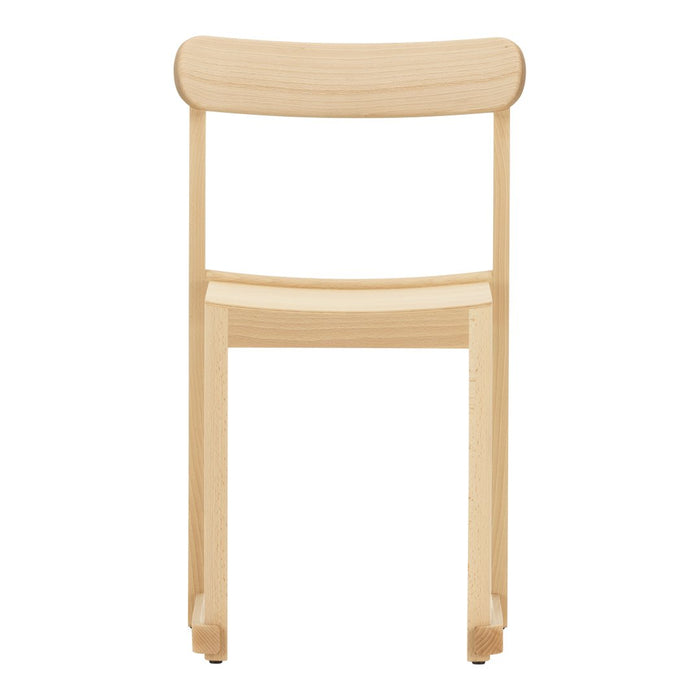 Light natural wood chair with a smooth, minimalist design and curved backrest, showcasing a simple, elegant finish.