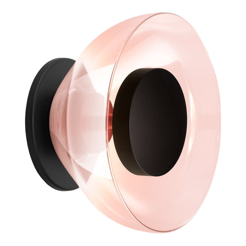 Pink and clear glass lamp with a black base, featuring a smooth, modern design and sleek, circular patterns.