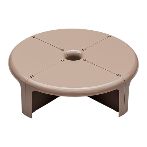 Round beige stool with subtle dark lines, featuring a smooth, glossy finish and a central hole design.